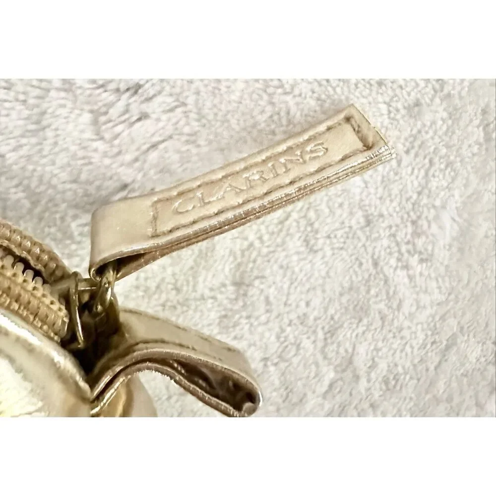 White gold Clarins cosmetic zip up bag